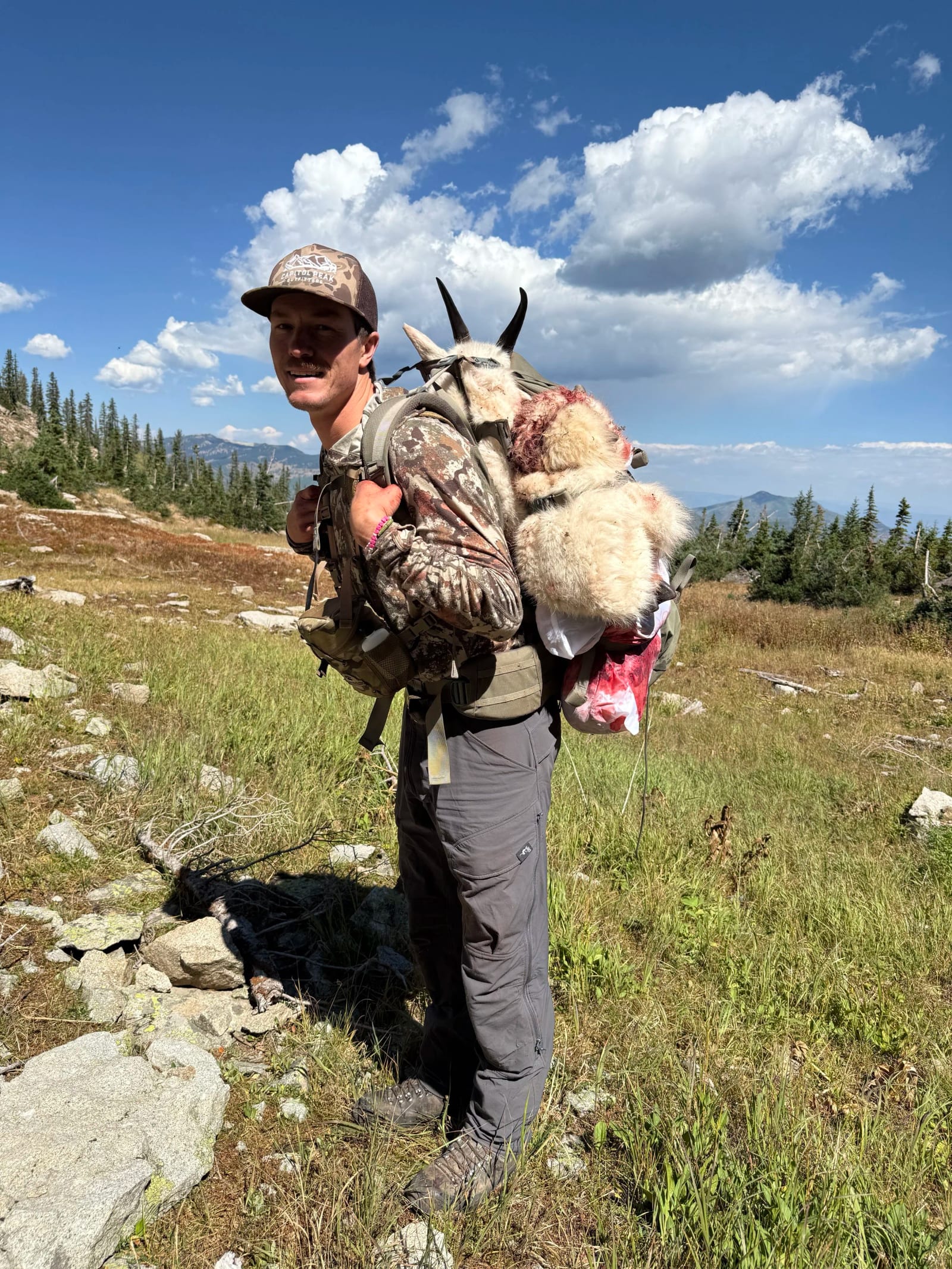 Guide Ted Benge packing out a billy mountain goat in GMU 11 Colorado