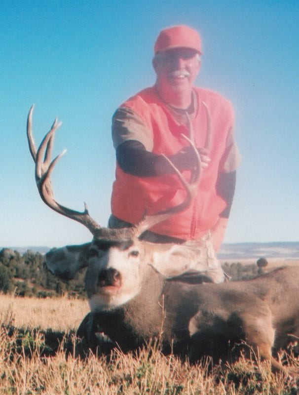 hunter holding a mule deer