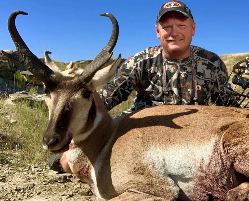A hunter poses with a harvested pronghorn.