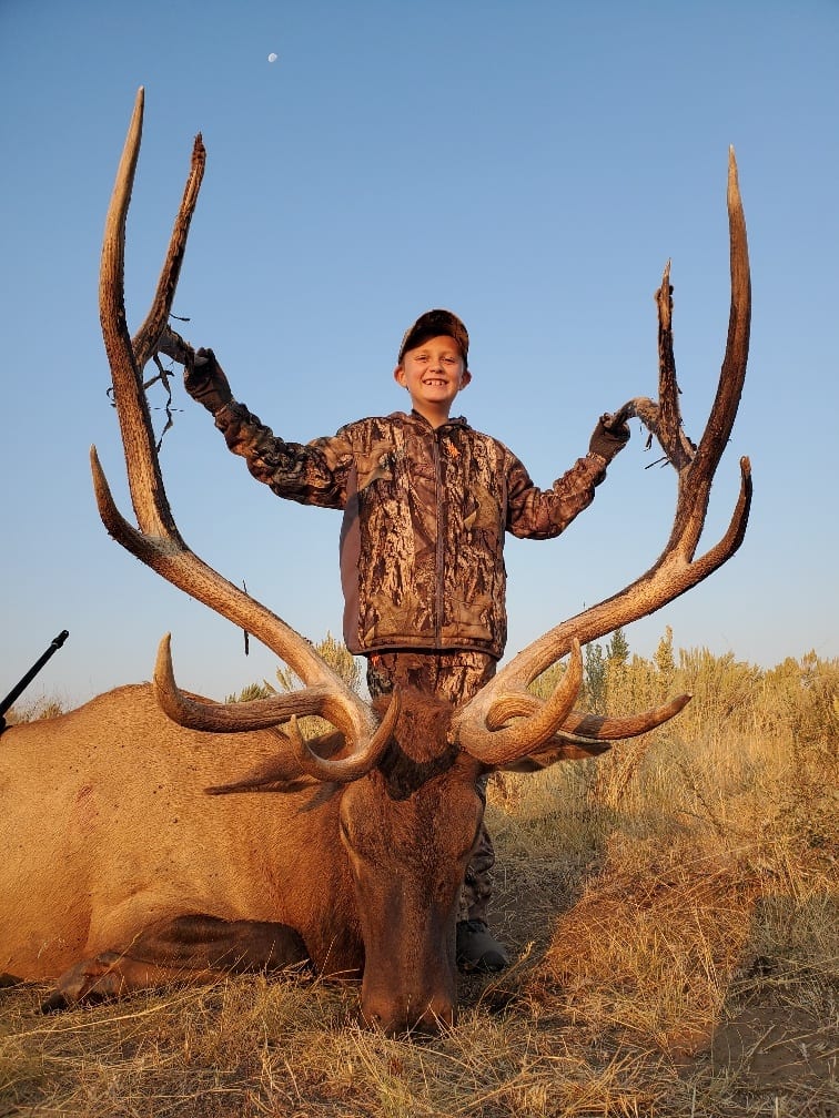 A young hunter poses with a harvested elk.