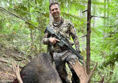 Hunter poses with elk on hunting trip