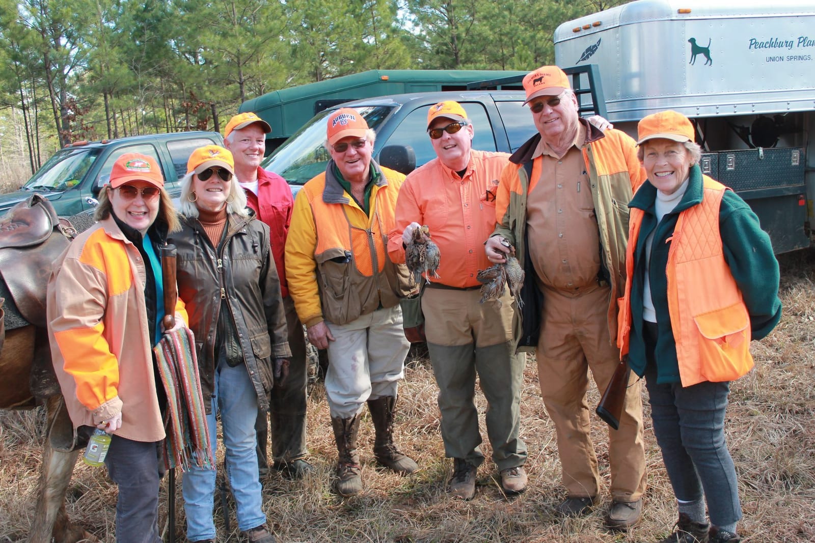 A group of hunters poses with harvested northern bobwhite quail.