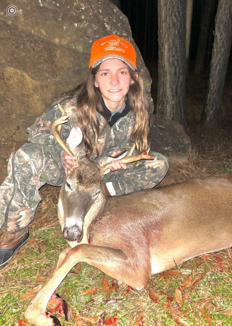 Girl posing with a harvested deer.