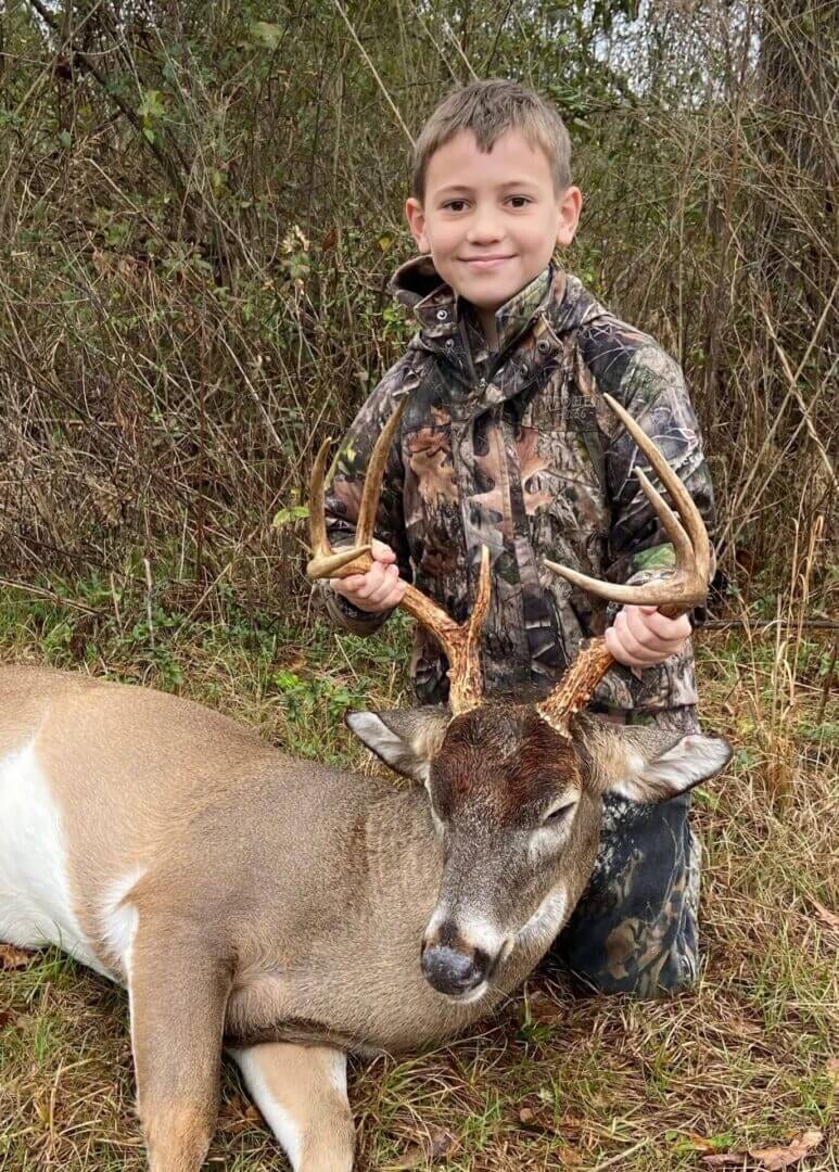 boy holding deer antlers
