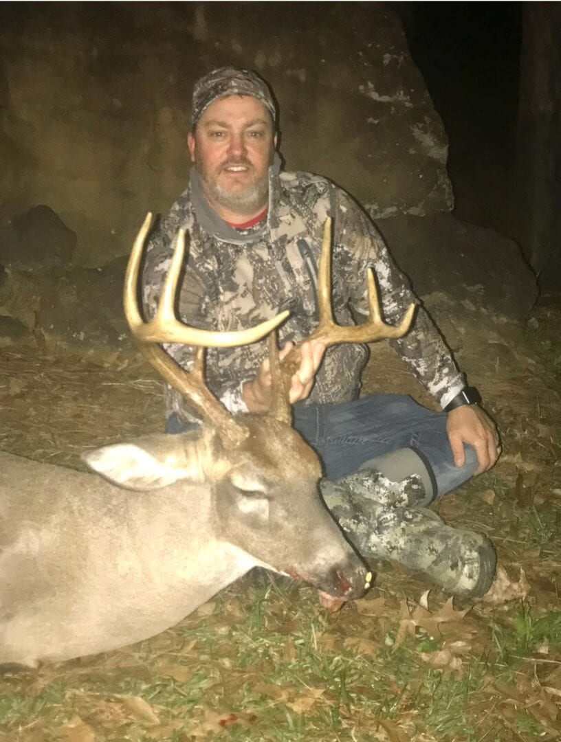 Hunter poses with a harvested deer.